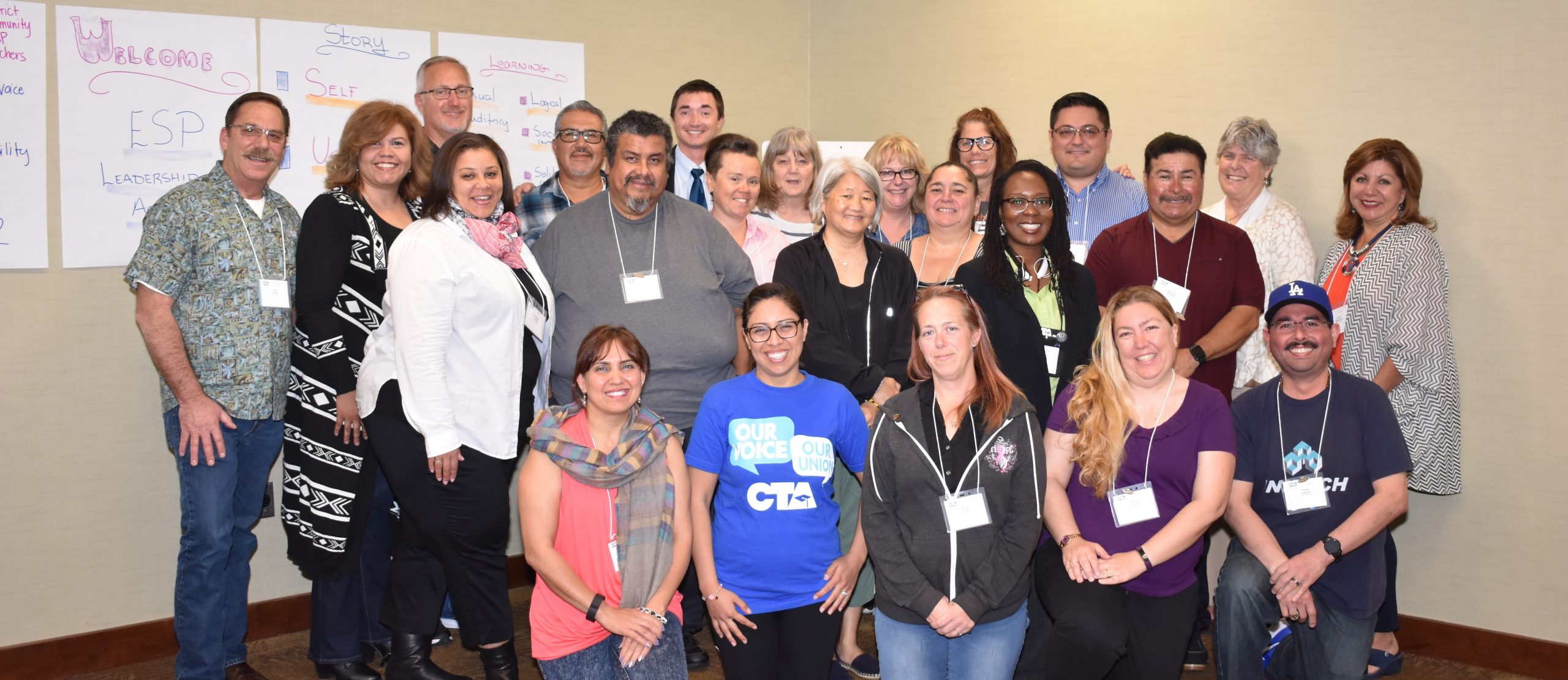 group of education support professionals standing and smiling