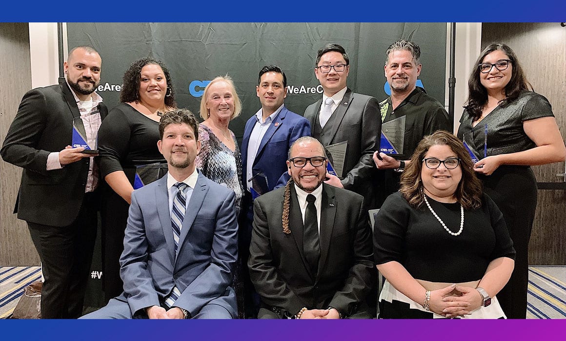 Seven award winners standing and three CTA officers seated at awards ceremony