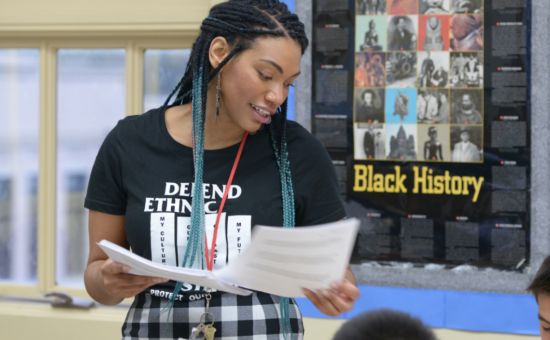 An educator wearing a "defend ethnic studies" t-shirt