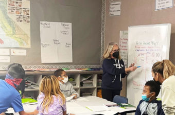 Amy Eytchison teaching class. All are wearing masks.