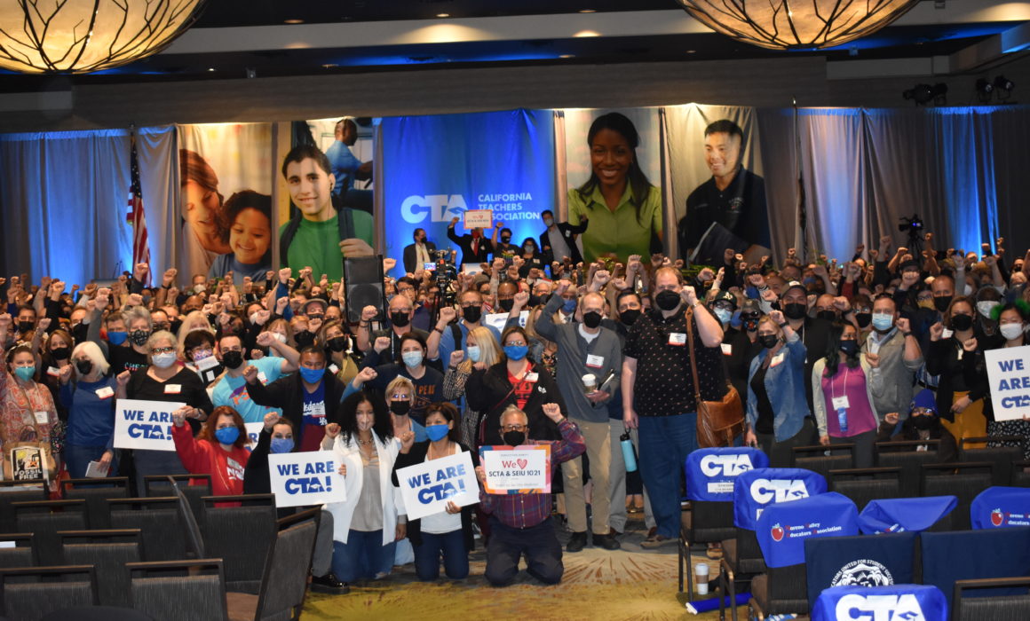 CTA members attending State Council raise fists in support of Sacramento teachers.