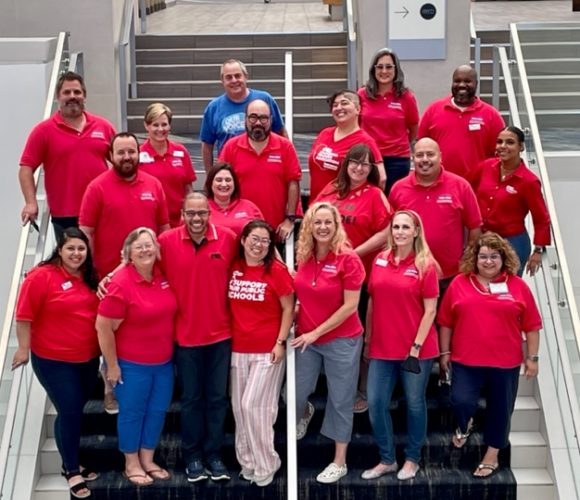 a group of people wearing red shirts