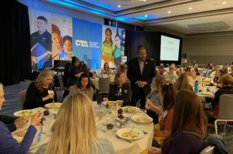 CTA President E. Toby Boyd checks in on members before his keynote on Saturday.
