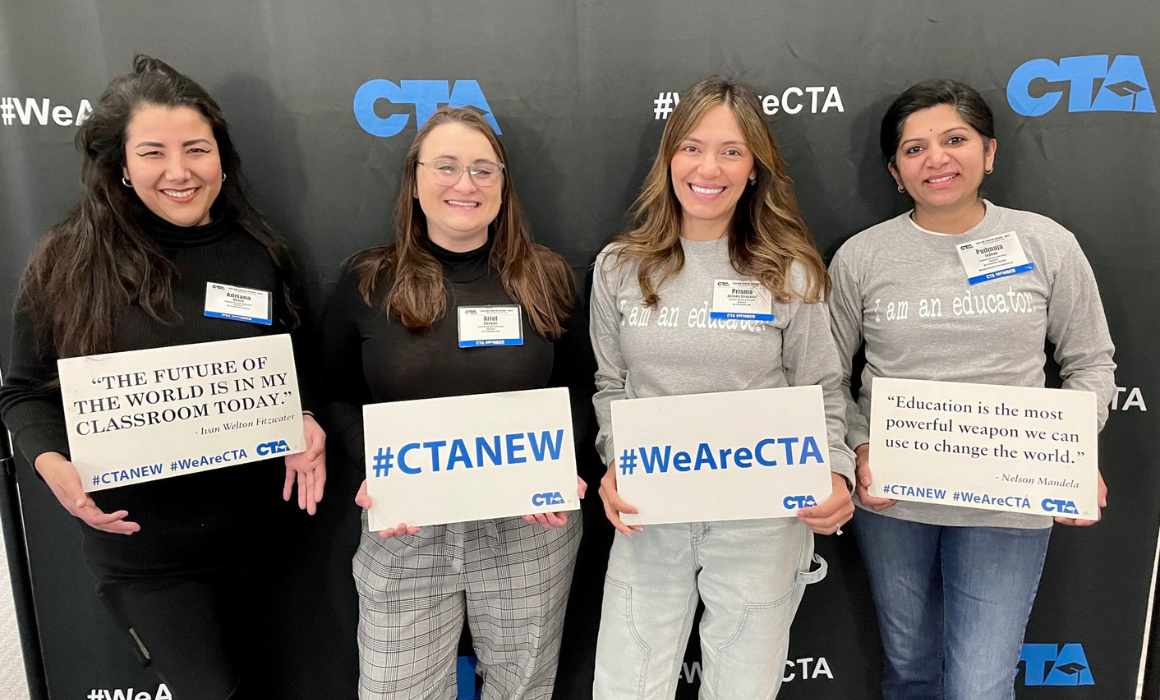 four women holding signs