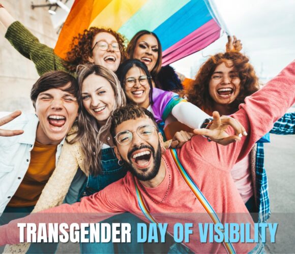 Graphic with an Image of people, a rainbow flag behind them, and the words Transgender Day of Visibility displayed.