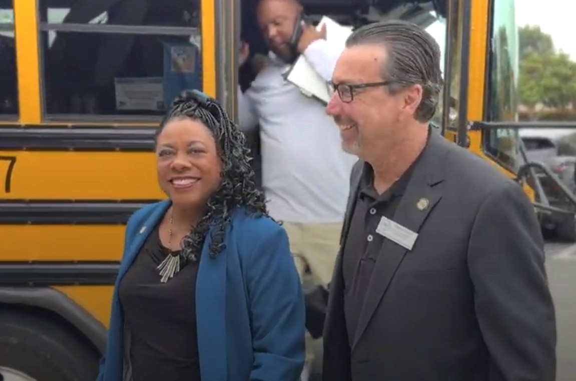 NEA President Becky Pringle steps off the bus withCTA Board Member Grant Schuster on her visit to Anaheim community schools.