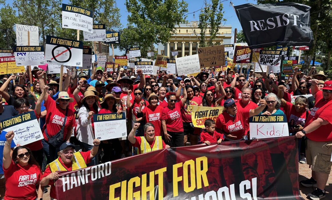 Labor activist Dolores Huerta, center, stands with the crowd in Hanford to defend and protect students, public schools and communities.