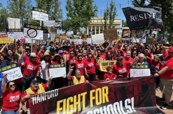 Labor activist Dolores Huerta, center, stands with the crowd in Hanford to defend and protect students, public schools and communities.