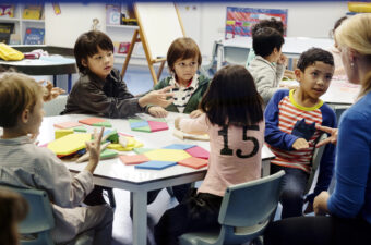 Stock photo of a teacher with elementary students