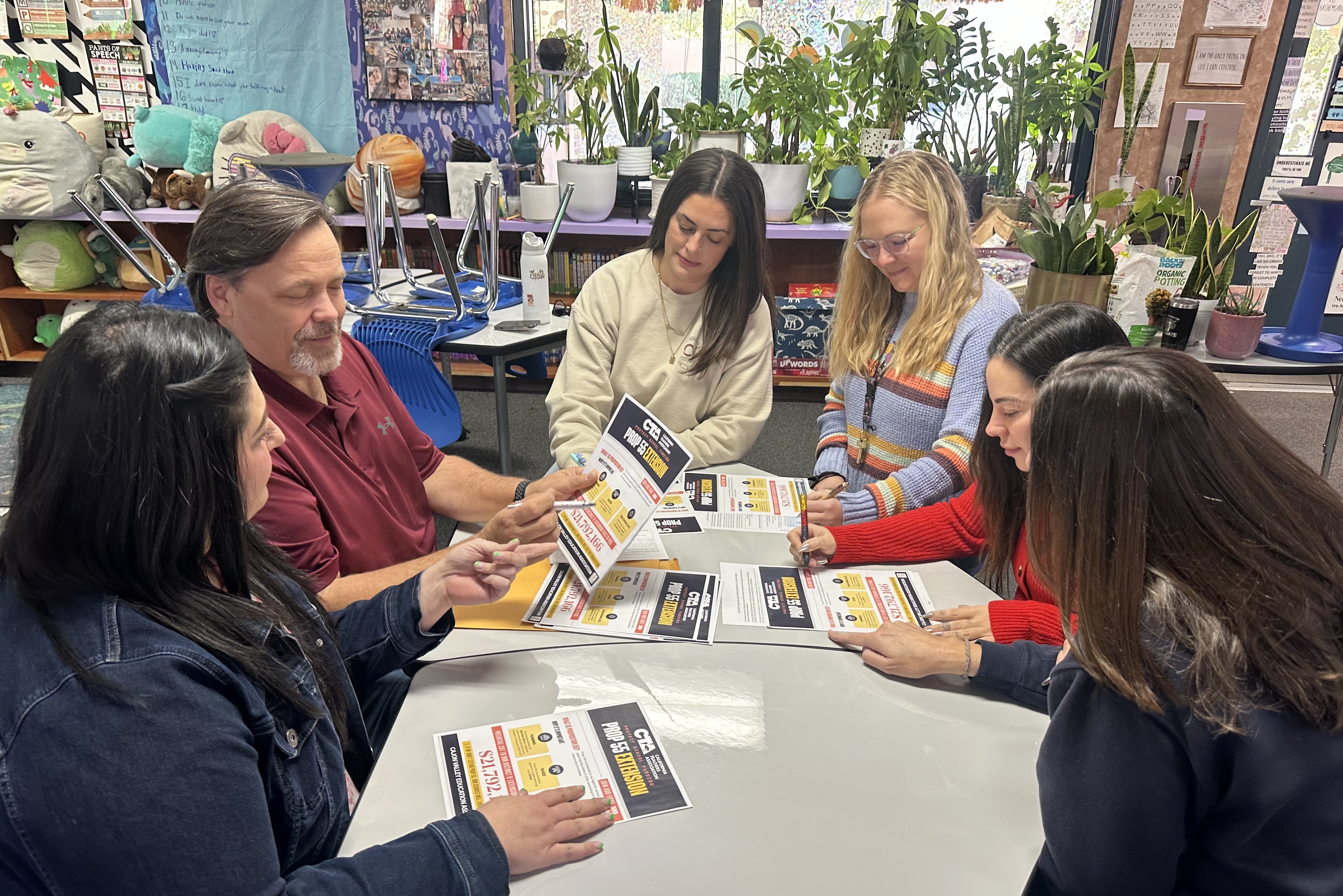 Left to right: Cajon Valley EA Site Rep Baha Hashemian, President StephenDavidson and other CVEA leaders discuss signature-gathering strategy.