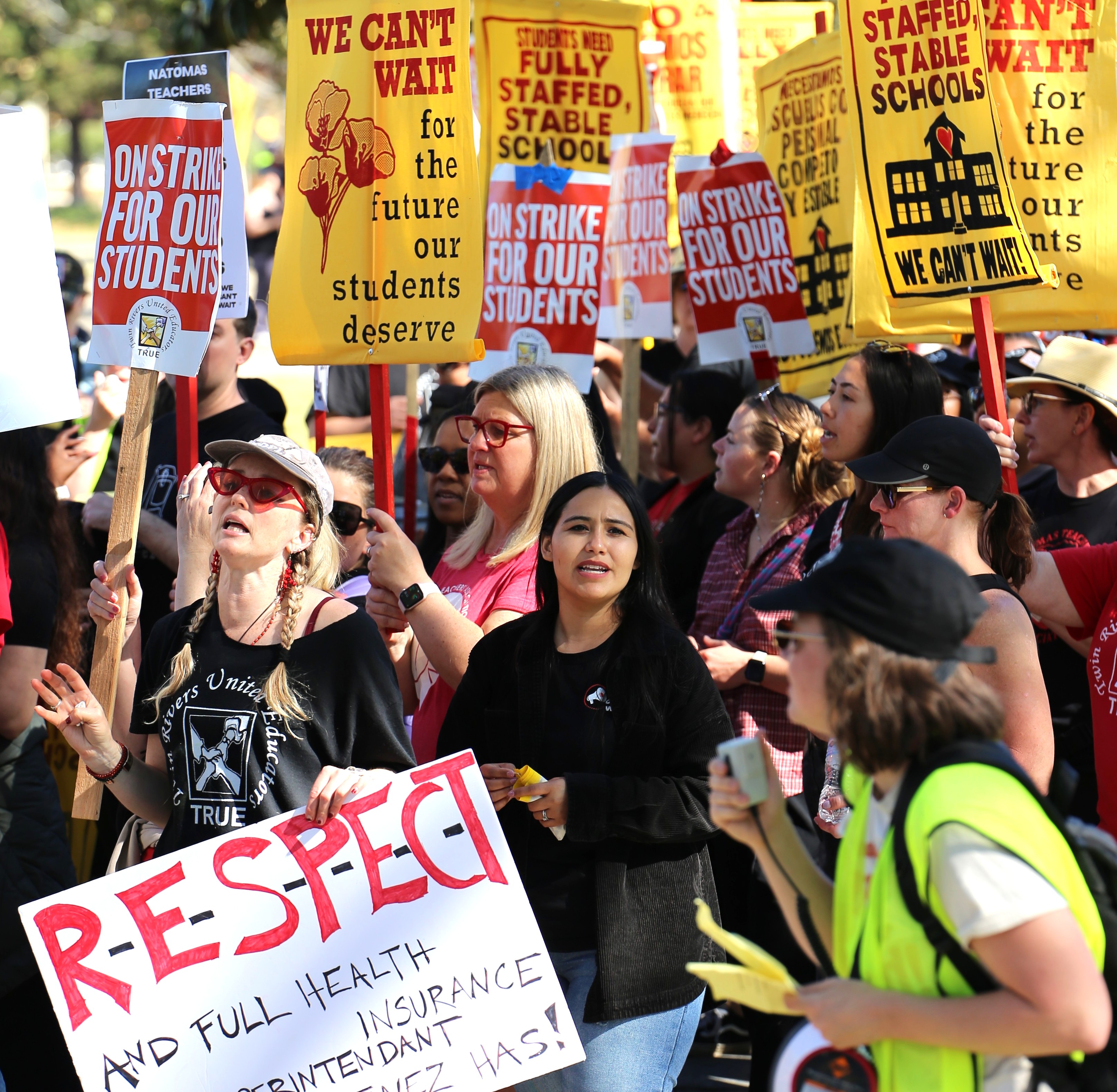 Striking Natomas Teachers Assn. members, below, and Twin Rivers United Educators members, at right, demand fairness — and paid health care.