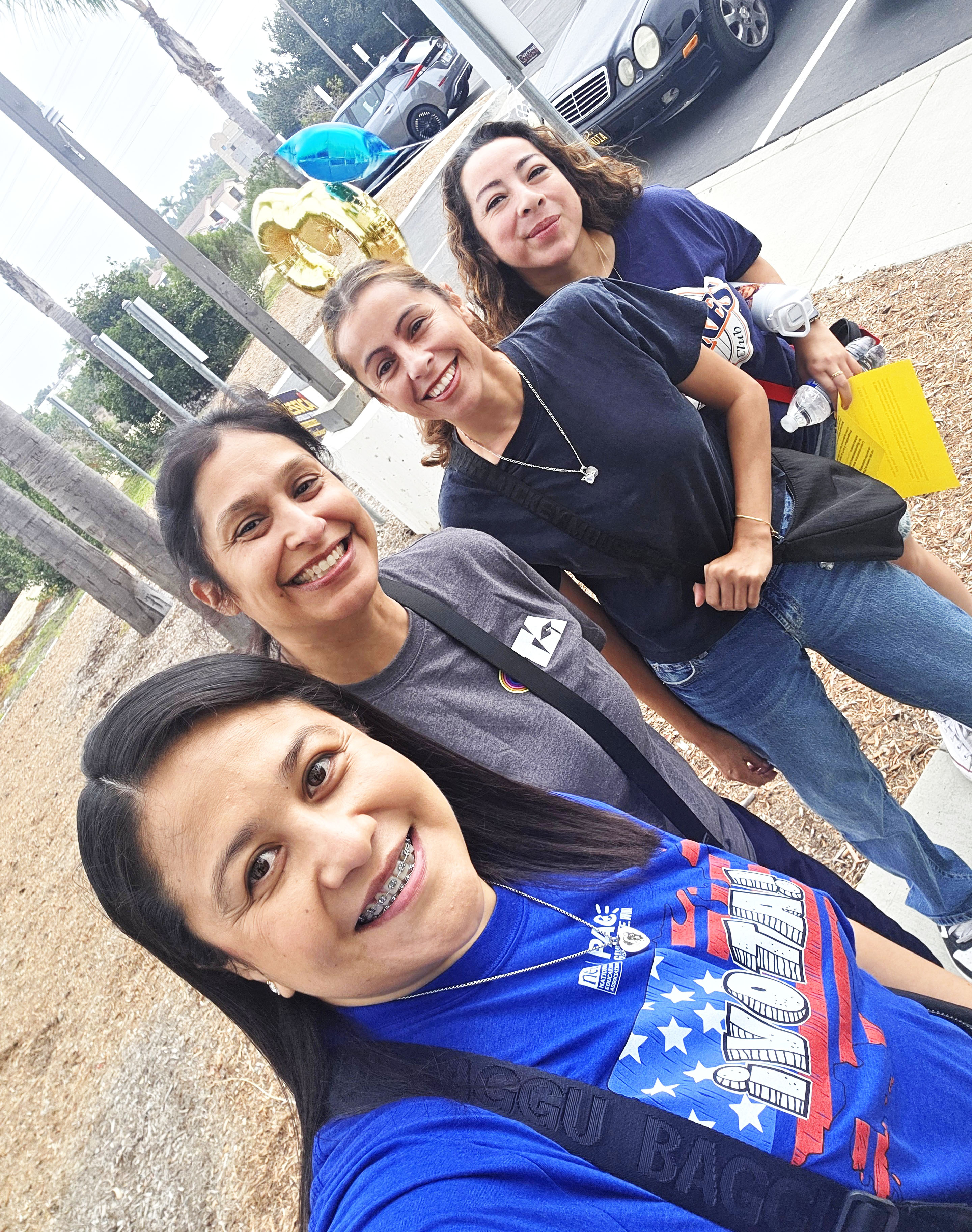 Southwest Teachers Assn. President Vanessa Barrera (at bottom) canvasseswith members — note the Prop. 3 balloon!